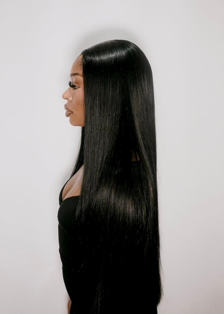 Person with long black hair against a white background